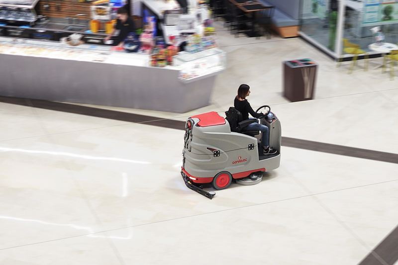 Ride-on floor scrubber working in a shopping mall